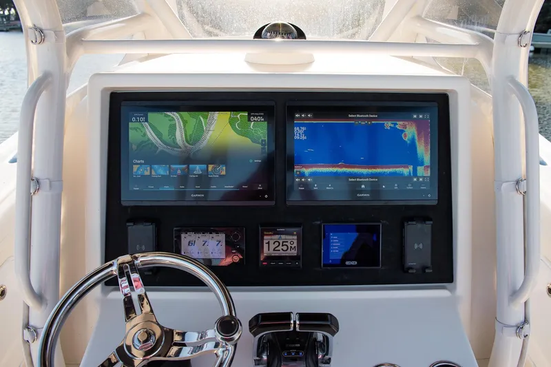 Slide: The Image of Dashboard of a 2014 Yellowfin 34 Offshore boat with navigation screens. - 19