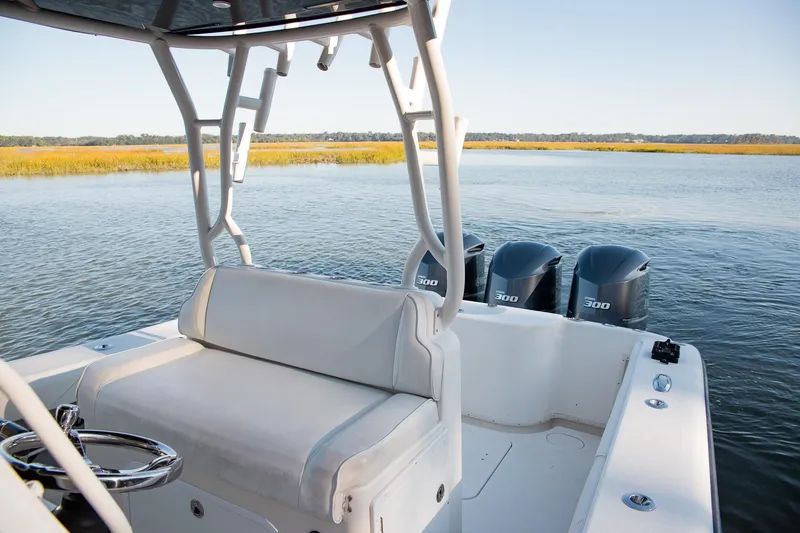 Slide: The Image of 2014 Yellowfin 34 Offshore boat with triple 300 horsepower engines on calm water. - 23