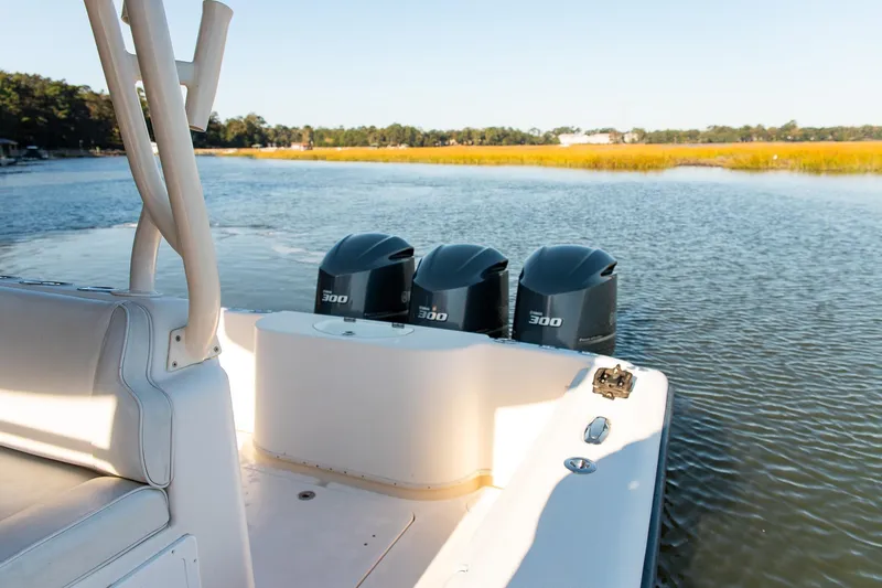 Slide: The Image of 2014 Yellowfin 34 Offshore boat with triple 300 horsepower engines on calm water. - 24