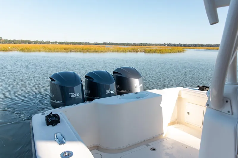 Slide: The Image of 2014 Yellowfin 34 Offshore boat with triple Yamaha 300 engines on calm water. - 25