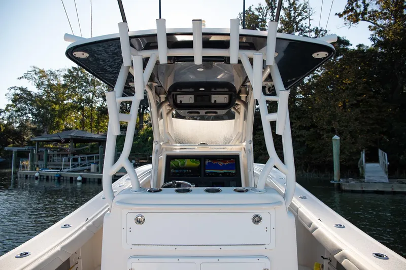 Slide: The Image of 2014 Yellowfin 34 Offshore boat cockpit with navigation screens and rod holders. - 27