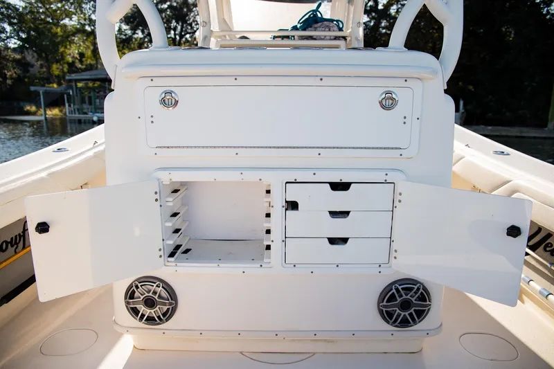 Slide: The Image of 2014 Yellowfin 34 Offshore boat storage compartments with open doors and speakers. - 28