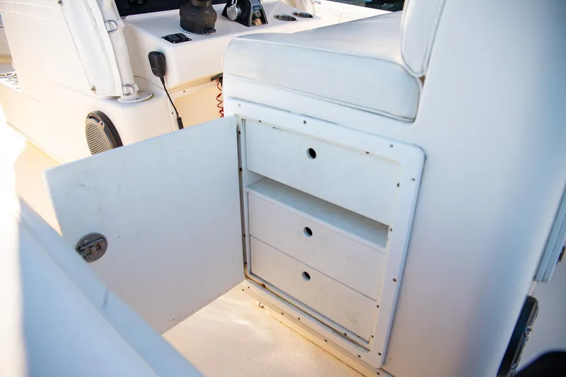 Slide: The Image of 2014 Yellowfin 34 Offshore boat interior storage compartment with open door and drawers. - 30