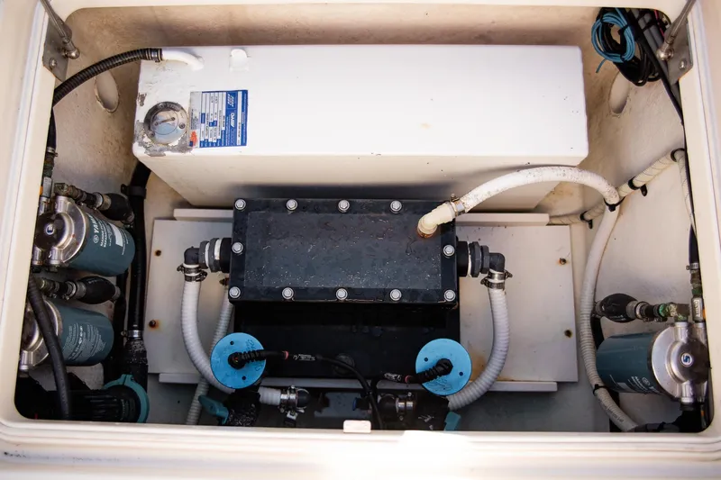 Slide: The Image of Engine compartment of a 2014 Yellowfin 34 Offshore boat, showcasing fuel filters and hoses. - 33