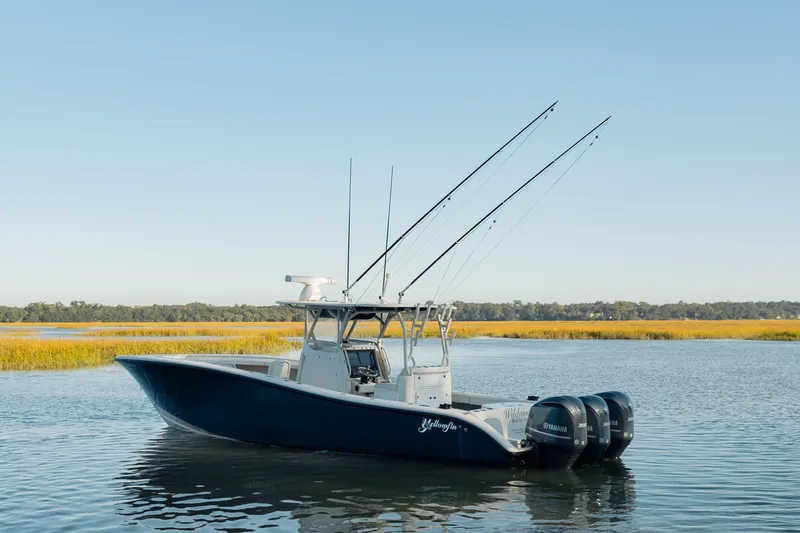 Slide: The Image of 2014 Yellowfin 34 Offshore boat on calm water, clear sky background. - 4