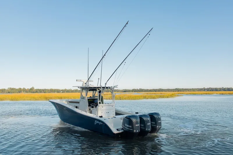 Slide: The Image of 2014 Yellowfin 34 Offshore boat on calm water with clear sky background. - 5