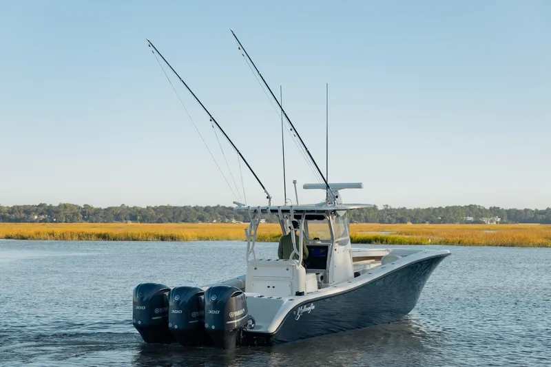 Slide: The Image of 2014 Yellowfin 34 Offshore boat with triple Yamaha engines on calm water. - 6