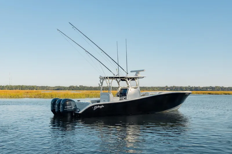 Slide: The Image of 2014 Yellowfin 34 Offshore boat with triple Yamaha engines on calm water. - 7