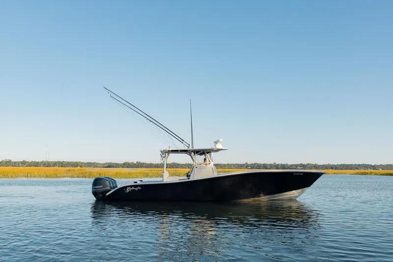 Slide: The Image of 2014 Yellowfin 34 Offshore boat with triple Yamaha engines on calm water. - 8