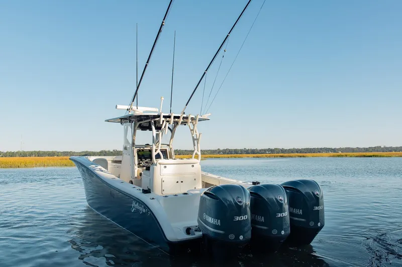 Slide: The Image of 2014 Yellowfin 34 Offshore boat with triple Yamaha engines on calm water. - 9