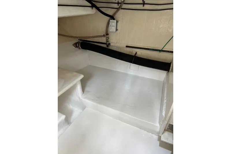 Slide: The Image of Clean interior of 2006 Norseman 480S boat, featuring white surfaces and visible piping. - 101