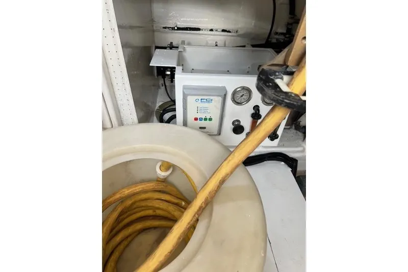 Slide: The Image of Engine room of 2006 Norseman 480S with equipment and coiled yellow hose. - 104