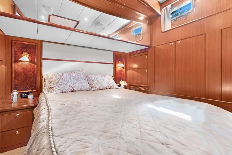 Slide: The Image of Luxurious bedroom interior of 2006 Noresman 480 Sedan yacht with wood paneling and cozy bedding. - 11