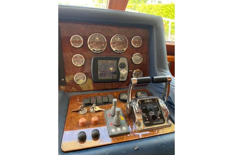 Slide: The Image of Control panel of a 2006 Norseman 480S boat with gauges and levers. - 115