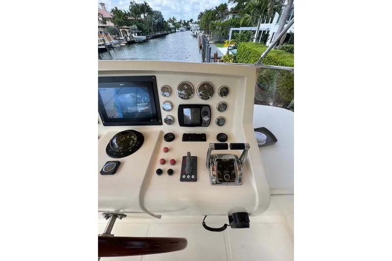 Slide: The Image of Control panel of a 2006 Norseman 480S yacht with navigation instruments and scenic waterway view. - 118