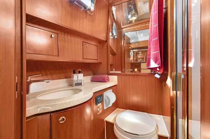 Slide: The Image of Luxurious 2006 Noresman 480 Sedan yacht bathroom with wood cabinetry and modern fixtures. - 12
