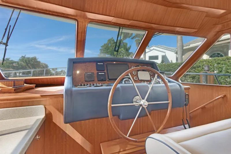 Slide: The Image of 2006 Noresman 480 Sedan yacht helm with wooden steering wheel and navigation controls. - 18