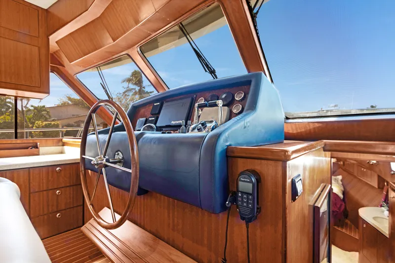 Slide: The Image of Interior of 2006 Noresman 480 Sedan yacht with wooden dashboard and steering wheel. - 19