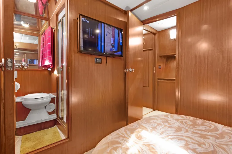 Slide: The Image of Luxurious 2006 Noresman 480 Sedan interior with wood paneling, TV, and bathroom. - 29