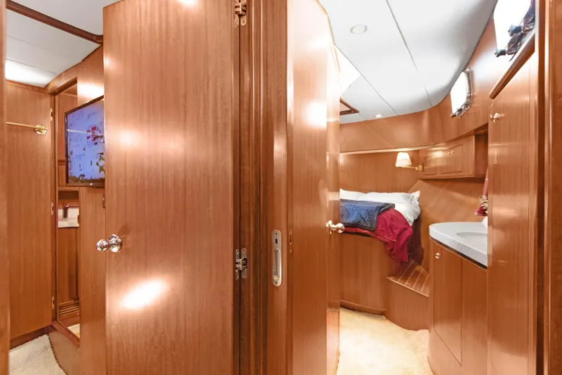 Slide: The Image of Luxurious 2006 Noresman 480 Sedan yacht interior with wood paneling and cozy bedroom. - 32