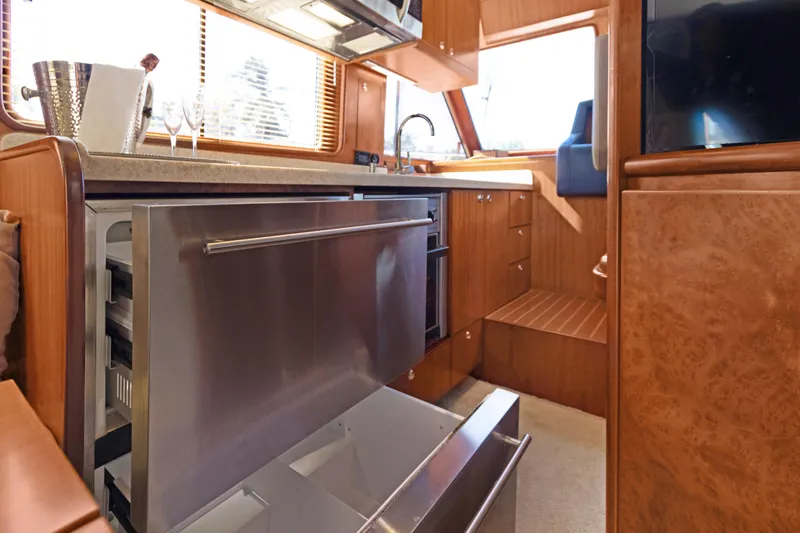 Slide: The Image of Luxurious 2006 Noresman 480 Sedan yacht interior with open stainless steel refrigerator. - 40