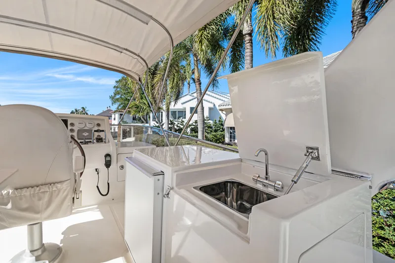 Slide: The Image of 2006 Noresman 480 Sedan boat interior with sink and steering area, under canopy. - 49