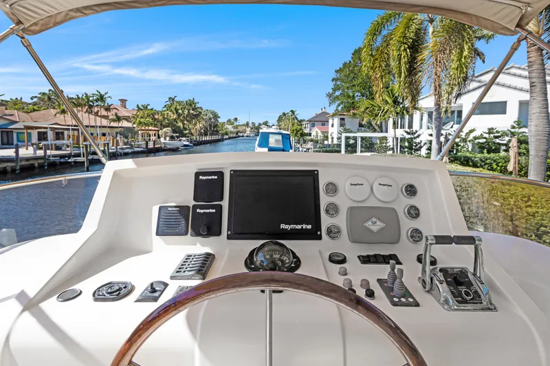 Slide: The Image of Helm of 2006 Noresman 480 Sedan yacht with canal view, featuring navigation equipment. - 51
