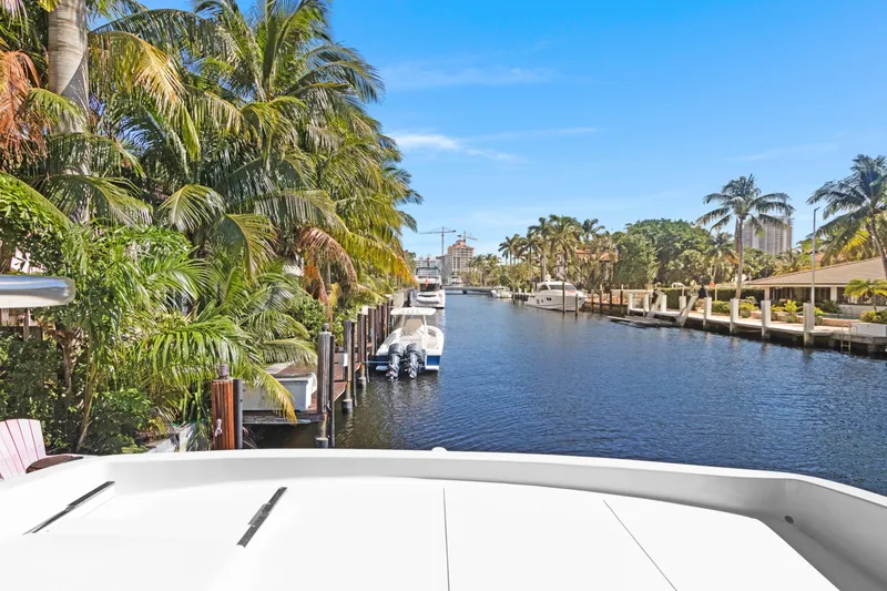 Slide: The Image of Tropical waterfront view from a 2006 Noresman 480 Sedan yacht, surrounded by palm trees and boats. - 58