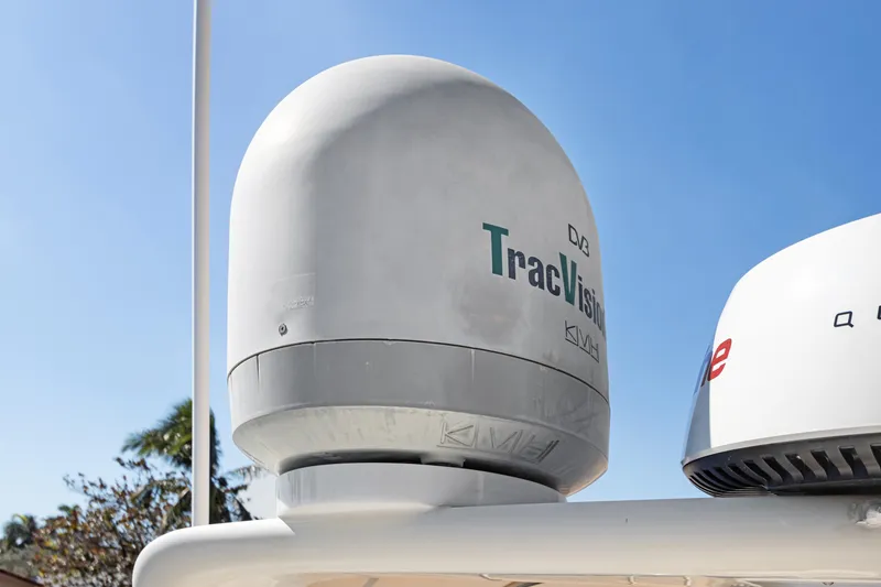 Slide: The Image of Satellite dome on 2006 Noresman 480 Sedan, featuring TracVision technology against clear blue sky. - 61