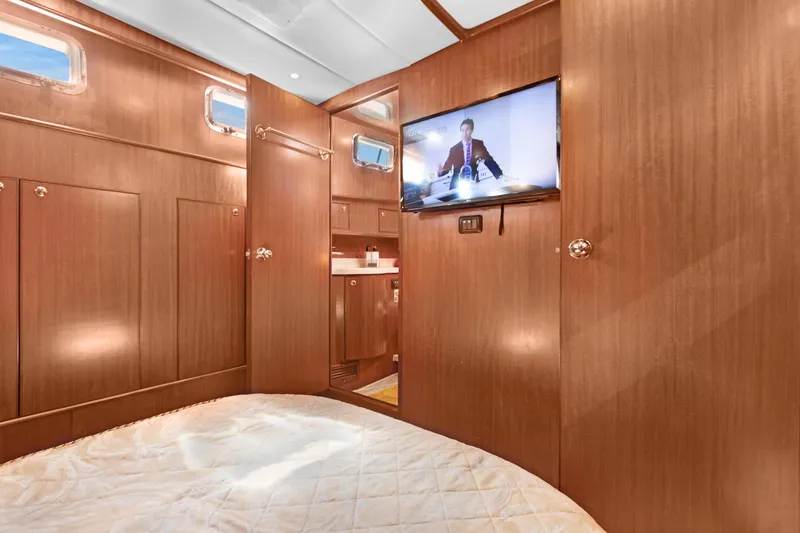 Slide: The Image of Luxurious 2006 Noresman 480 Sedan yacht interior with wood paneling and mounted TV. - 7