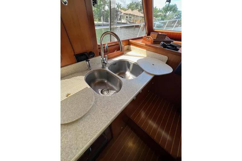 Slide: The Image of 2006 Norseman 480S yacht kitchen with dual sinks and wooden cabinetry. - 78