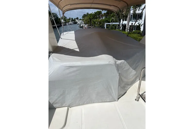 Slide: The Image of Covered deck area of 2006 Norseman 480S yacht, docked near waterfront homes. - 86