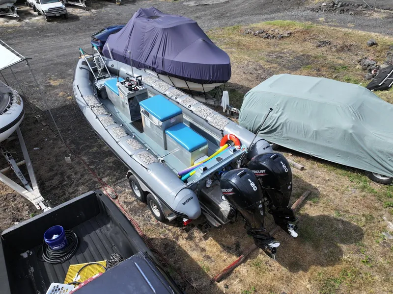 Slide: The Image of 2012 Zodiac 733 Hurricane boat with dual Mercury engines on a trailer. - 4