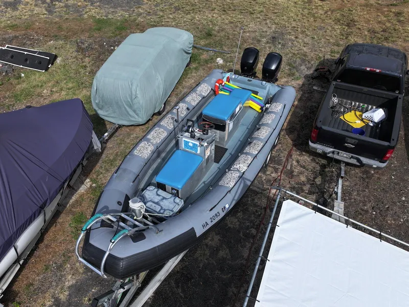 Slide: The Image of Aerial view of a 2012 Zodiac 733 Hurricane boat on a trailer beside a truck. - 6