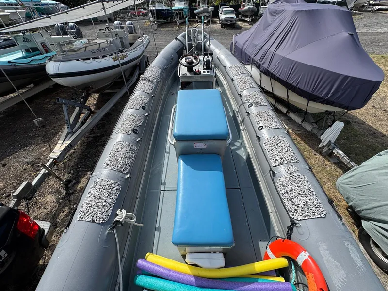 Slide: The Image of 2012 Zodiac 733 Hurricane boat with blue seating and colorful pool noodles on deck. - 8