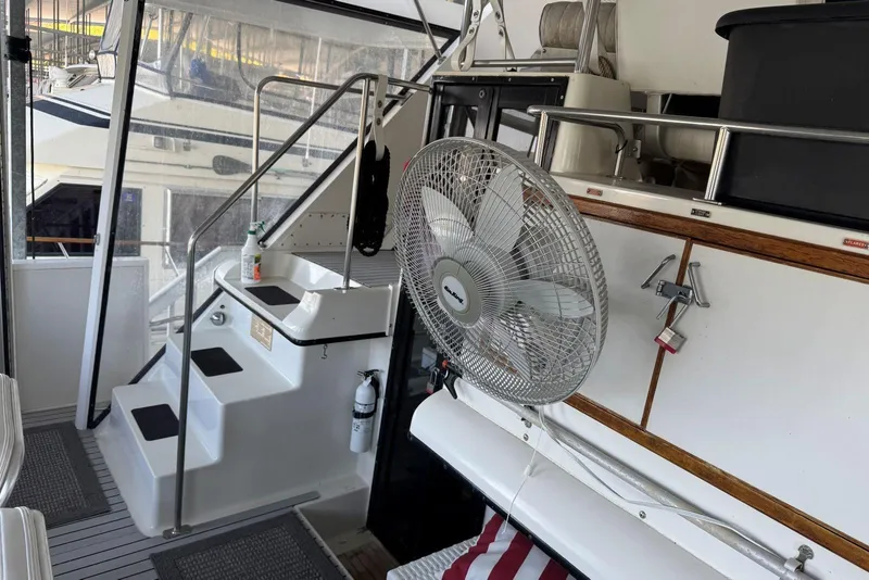 Slide: The Image of 1987 Carver 42 Aft Cabin Motor Yacht interior with stairs, fan, and safety equipment. - 12