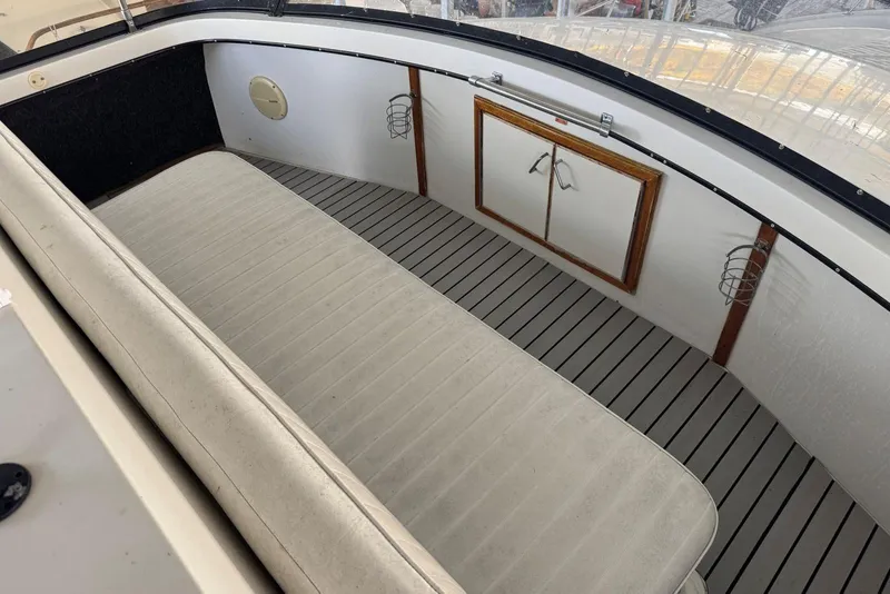 Slide: The Image of 1987 Carver 42 Aft Cabin Motor Yacht interior with cushioned seating and storage. - 19