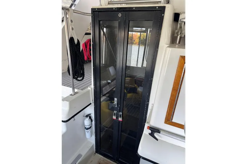 Slide: The Image of 1987 Carver 42 Aft Cabin Motor Yacht interior with glass doors and deck view. - 23