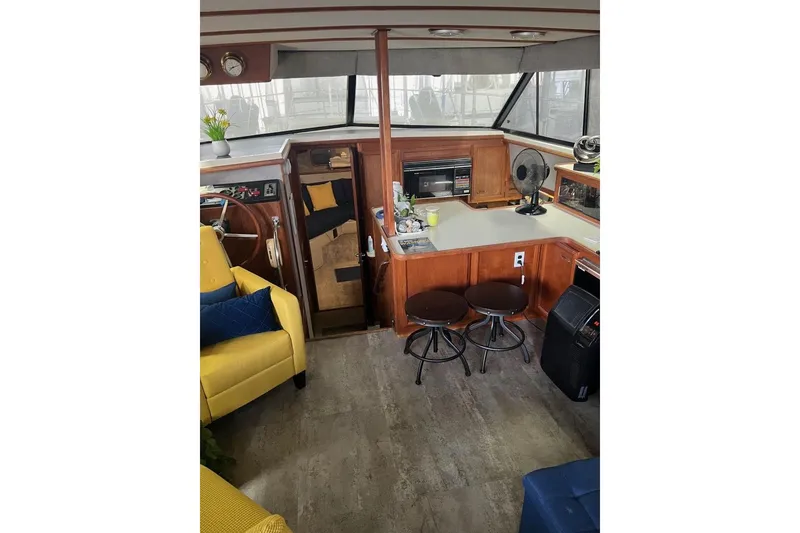 Slide: The Image of Interior of 1987 Carver 42 Aft Cabin Motor Yacht with cozy seating and kitchenette. - 25