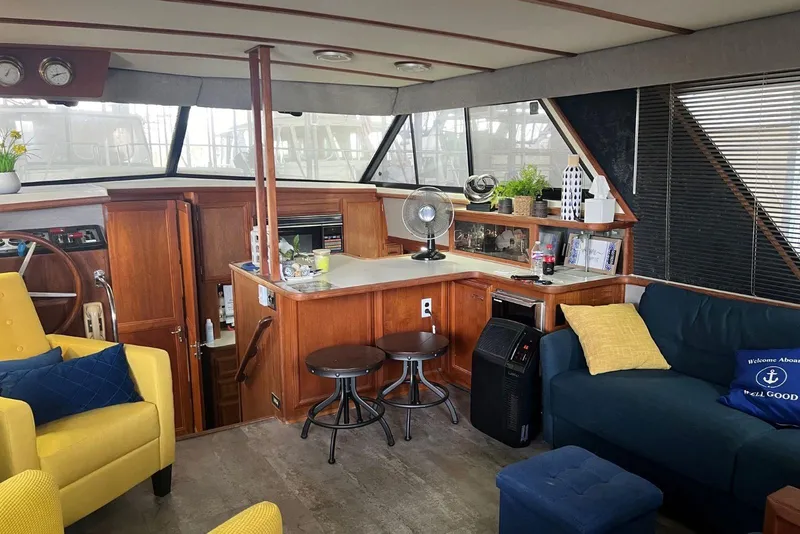 Slide: The Image of Interior of 1987 Carver 42 Aft Cabin Motor Yacht with cozy seating and decor. - 26