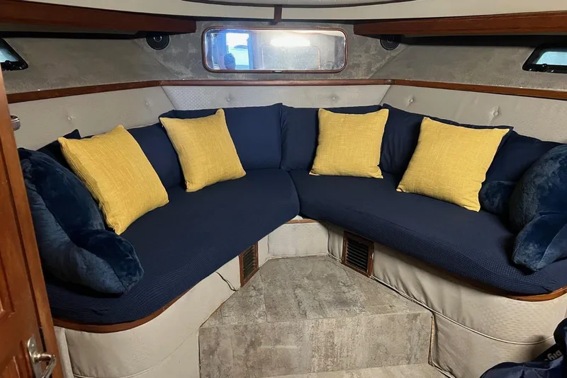 Slide: The Image of 1987 Carver 42 Aft Cabin Motor Yacht interior with blue and yellow cushions. - 32