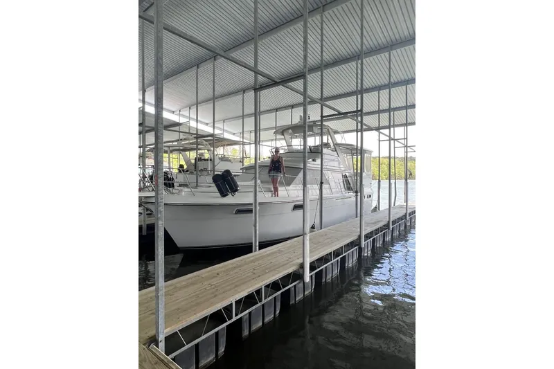 Slide: The Image of 1987 Carver 42 Aft Cabin Motor Yacht docked in a covered marina. - 4