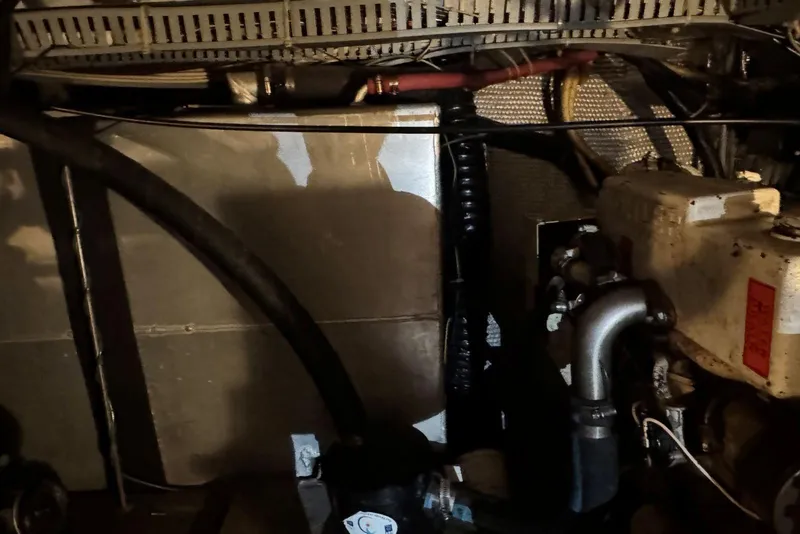 Slide: The Image of Engine room of 1987 Carver 42 Aft Cabin Motor Yacht, showcasing mechanical components. - 52