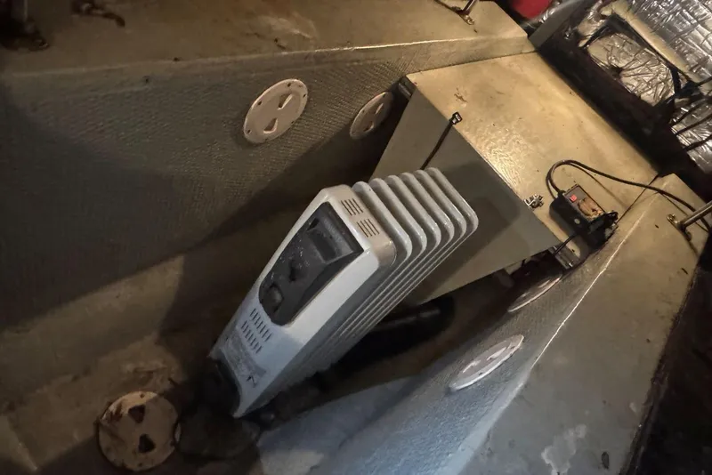 Slide: The Image of 1987 Carver 42 Aft Cabin Motor Yacht engine room with heater and battery charger. - 55