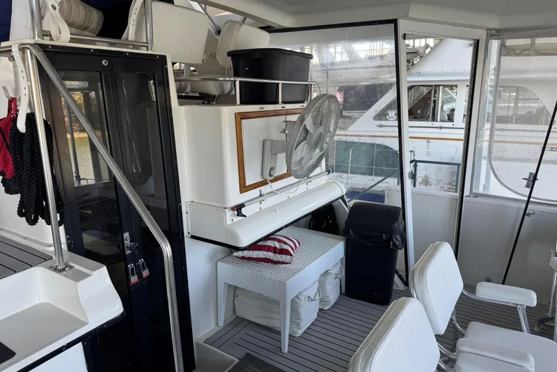 Slide: The Image of 1987 Carver 42 Aft Cabin Motor Yacht interior with seating and fan. - 10