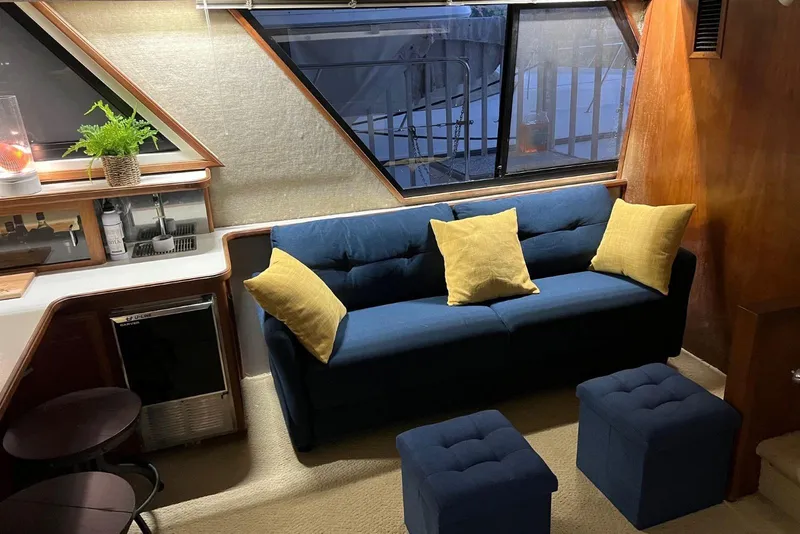 Slide: The Image of Interior of 1987 Carver 42 Aft Cabin Motor Yacht with blue sofa and yellow pillows. - 29