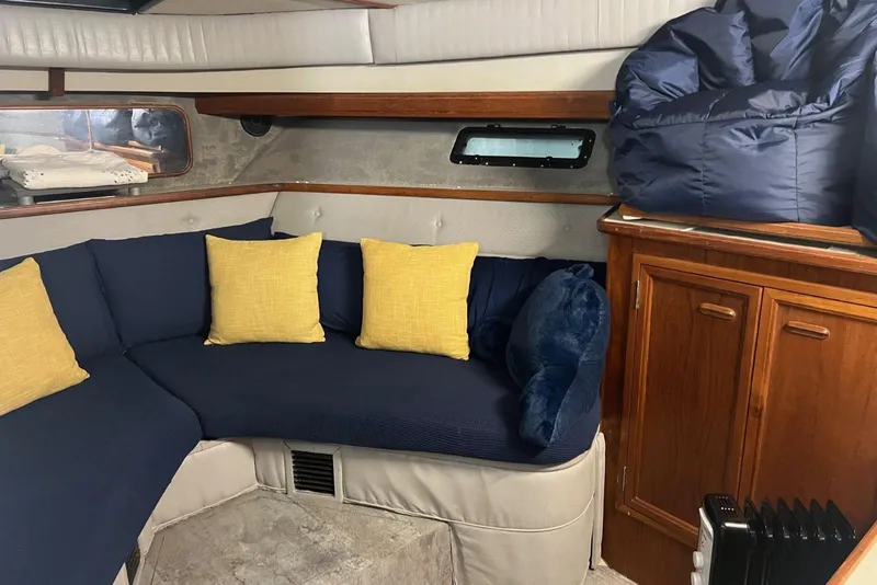 Slide: The Image of 1987 Carver 42 Aft Cabin Motor Yacht interior with blue seating and yellow cushions. - 33