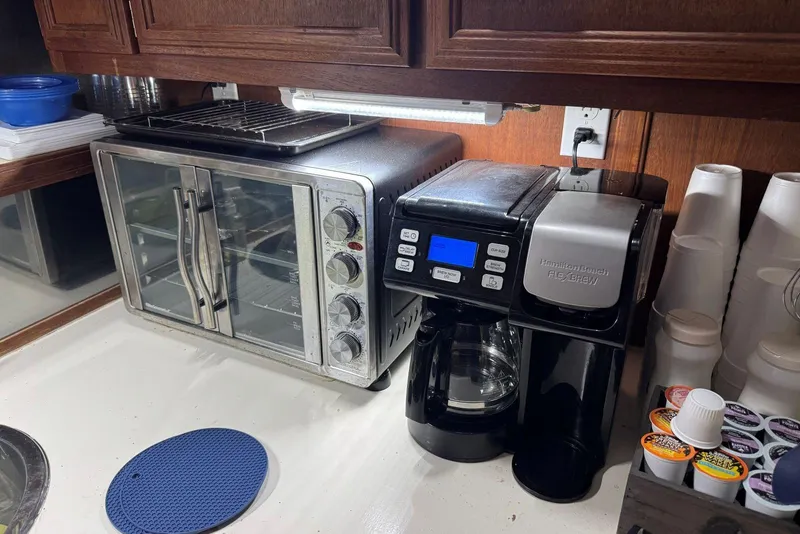 Slide: The Image of Kitchen appliances on a 1987 Carver 42 Aft Cabin Motor Yacht, featuring a toaster oven and coffee maker. - 38