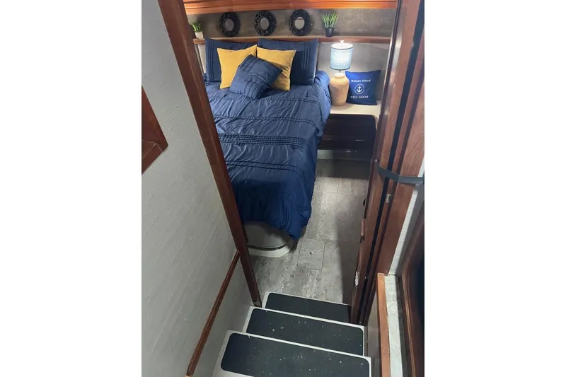 Slide: The Image of Interior of 1987 Carver 42 Aft Cabin Motor Yacht with cozy bedroom setup. - 39