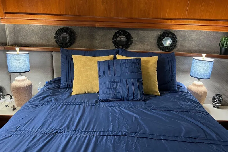 Slide: The Image of Luxurious bedroom in 1987 Carver 42 Aft Cabin Motor Yacht with blue bedding and lamps. - 41